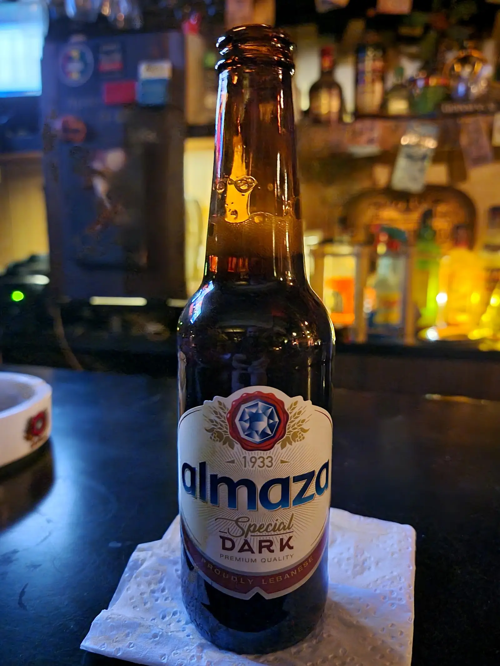 A cold bottle of Almaza, the Lebanese lager, standing on the bar