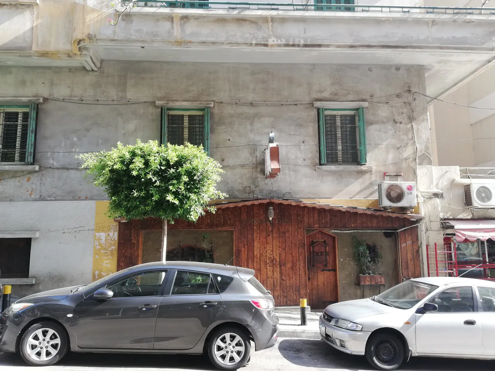 The street frontage and wooden door of Captain's Cabin in Hamra